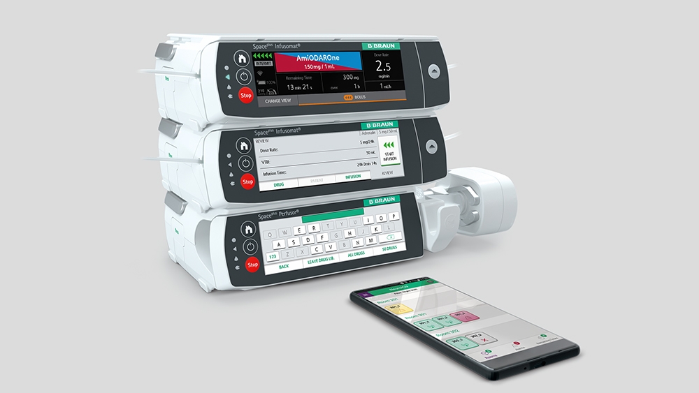Space Plus Infusion System and a smartphone laying in front of it with the associated app opened. 