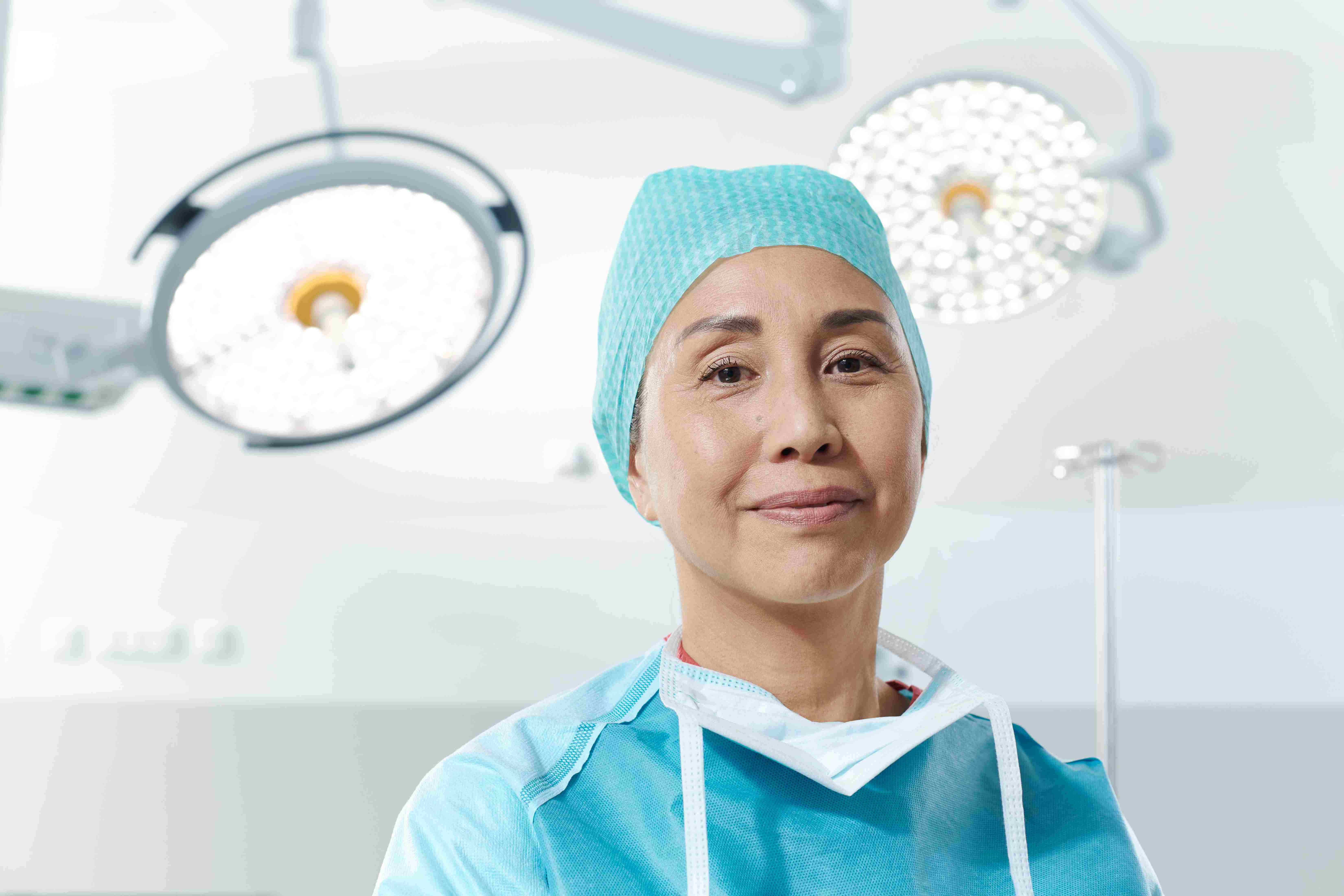 A healthcare professional is shown standing proudly with a sustainable-produced medical container.