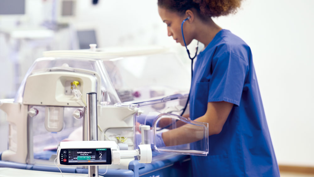 A nurse cares for a pediatric patient with a B. Braun smart infusion device nearby.